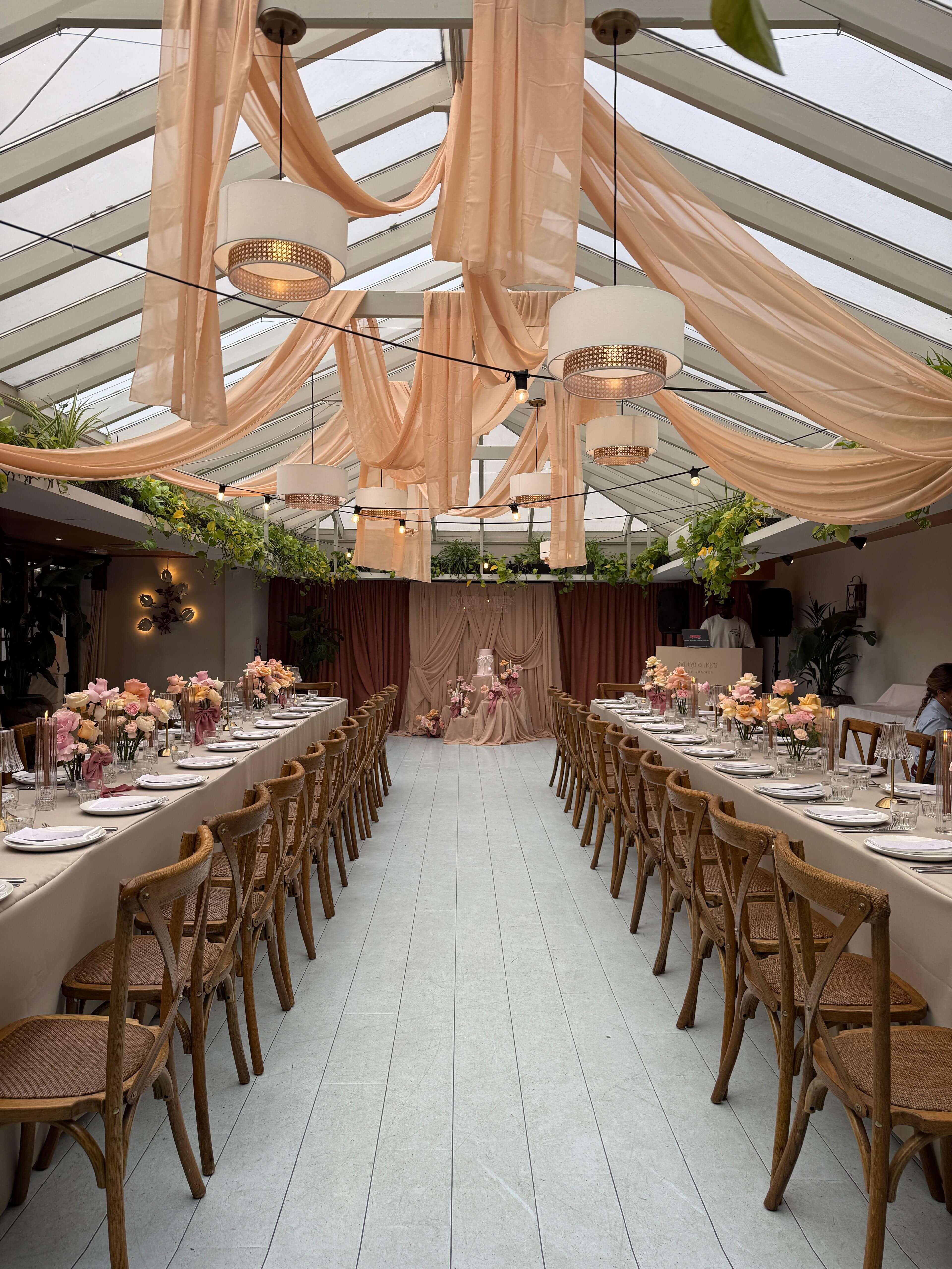 Elegant baby shower with peach draping and luxury table settings