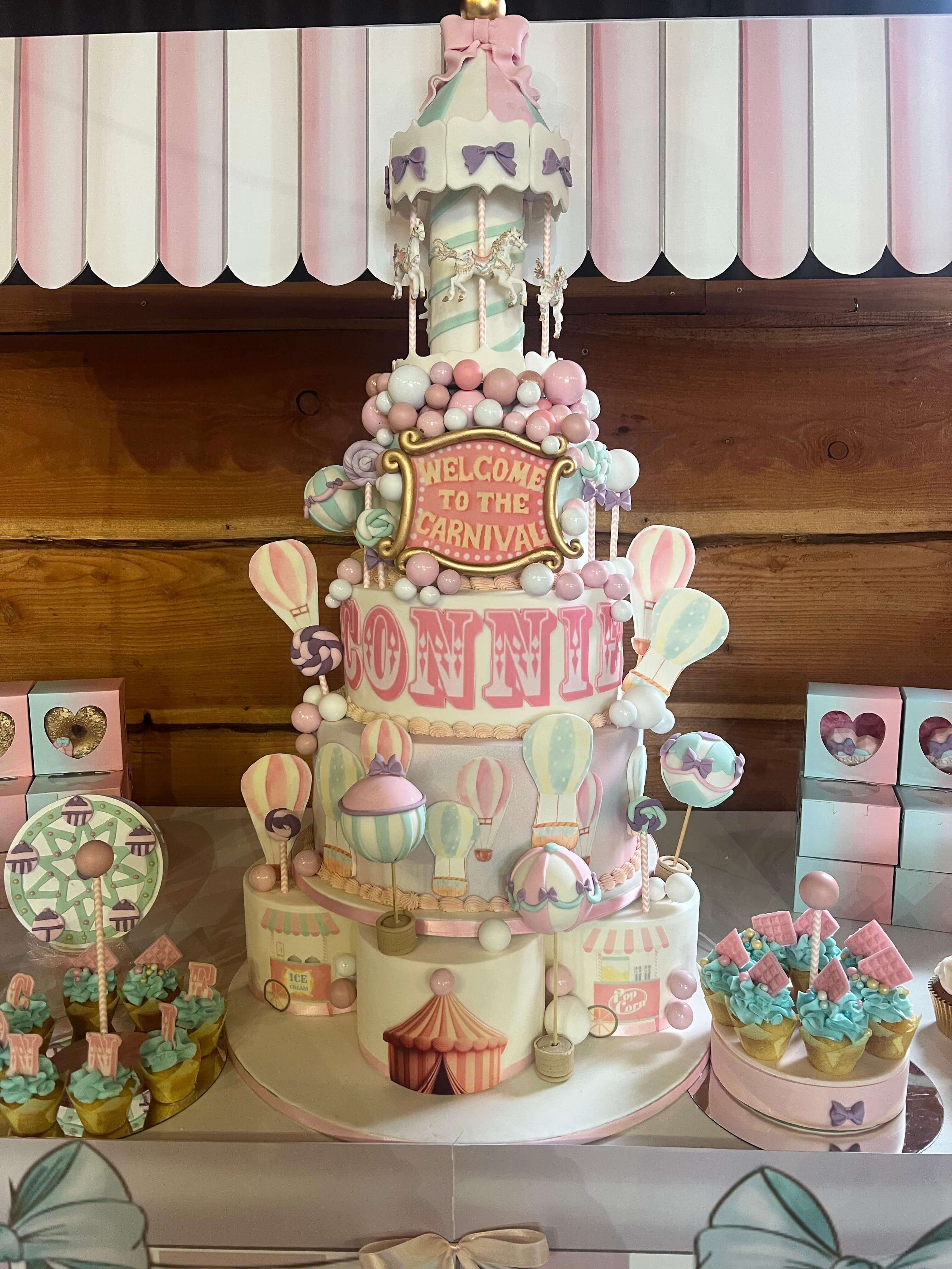 Elaborate pastel carnival birthday with carousel cake and hot air balloon decorations