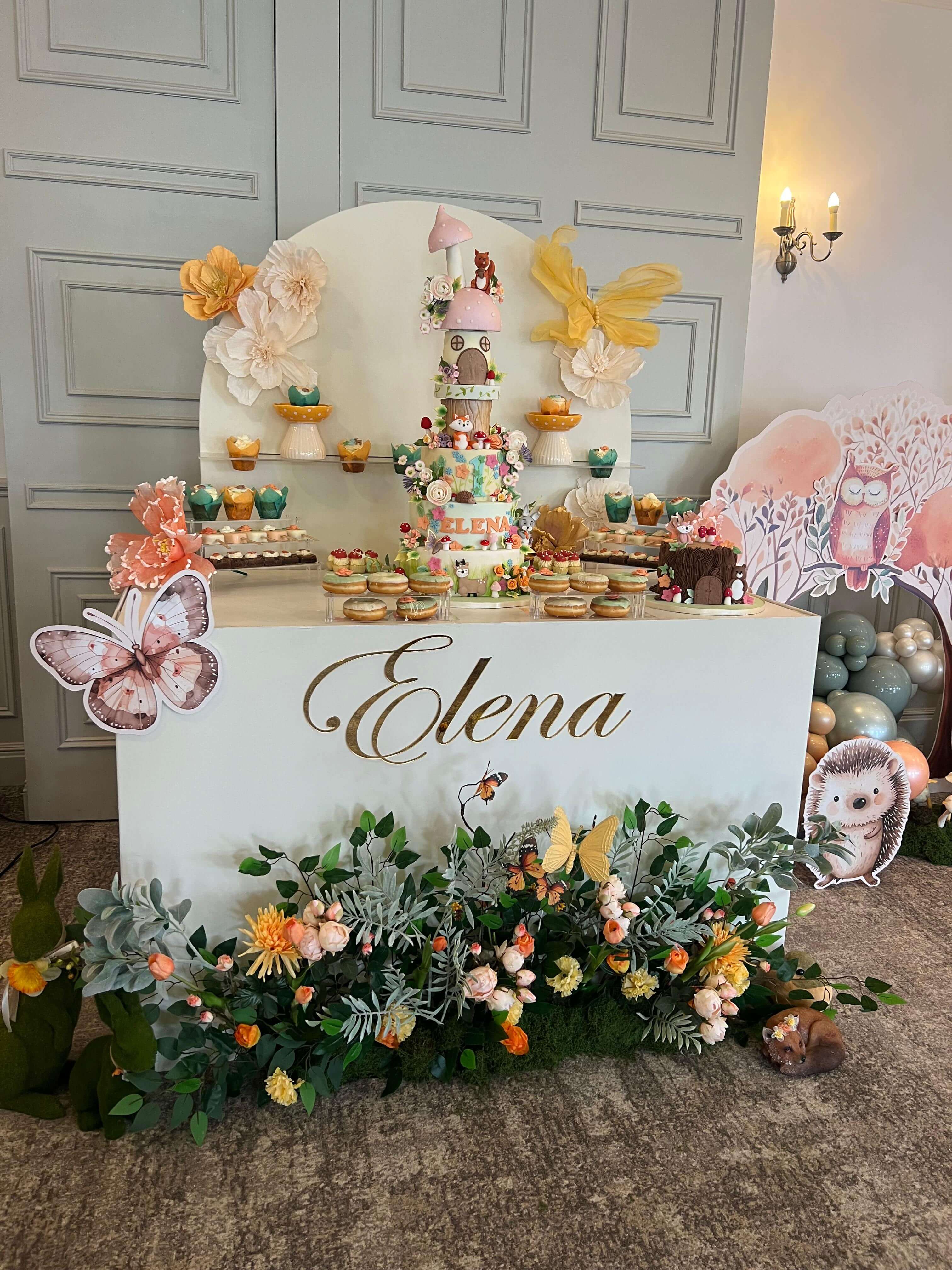 Enchanted forest woodland birthday with butterfly decorations and whimsical castle cake