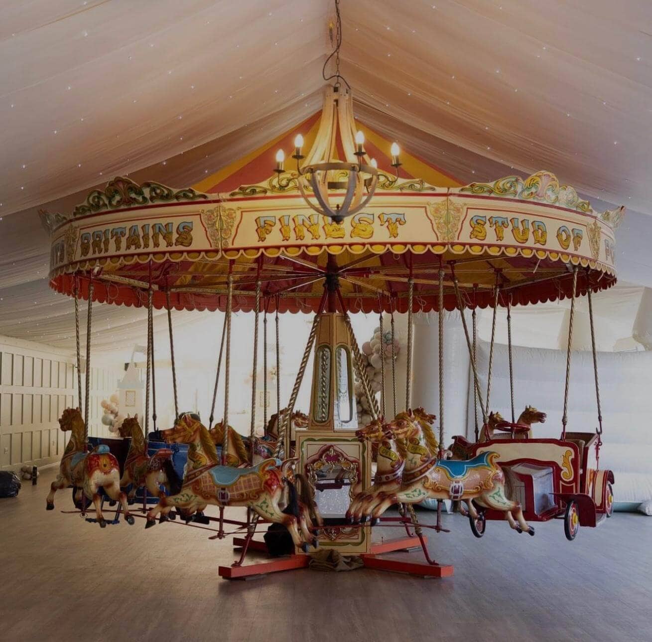 Whimsical birthday celebration with vintage carousel in elegant venue