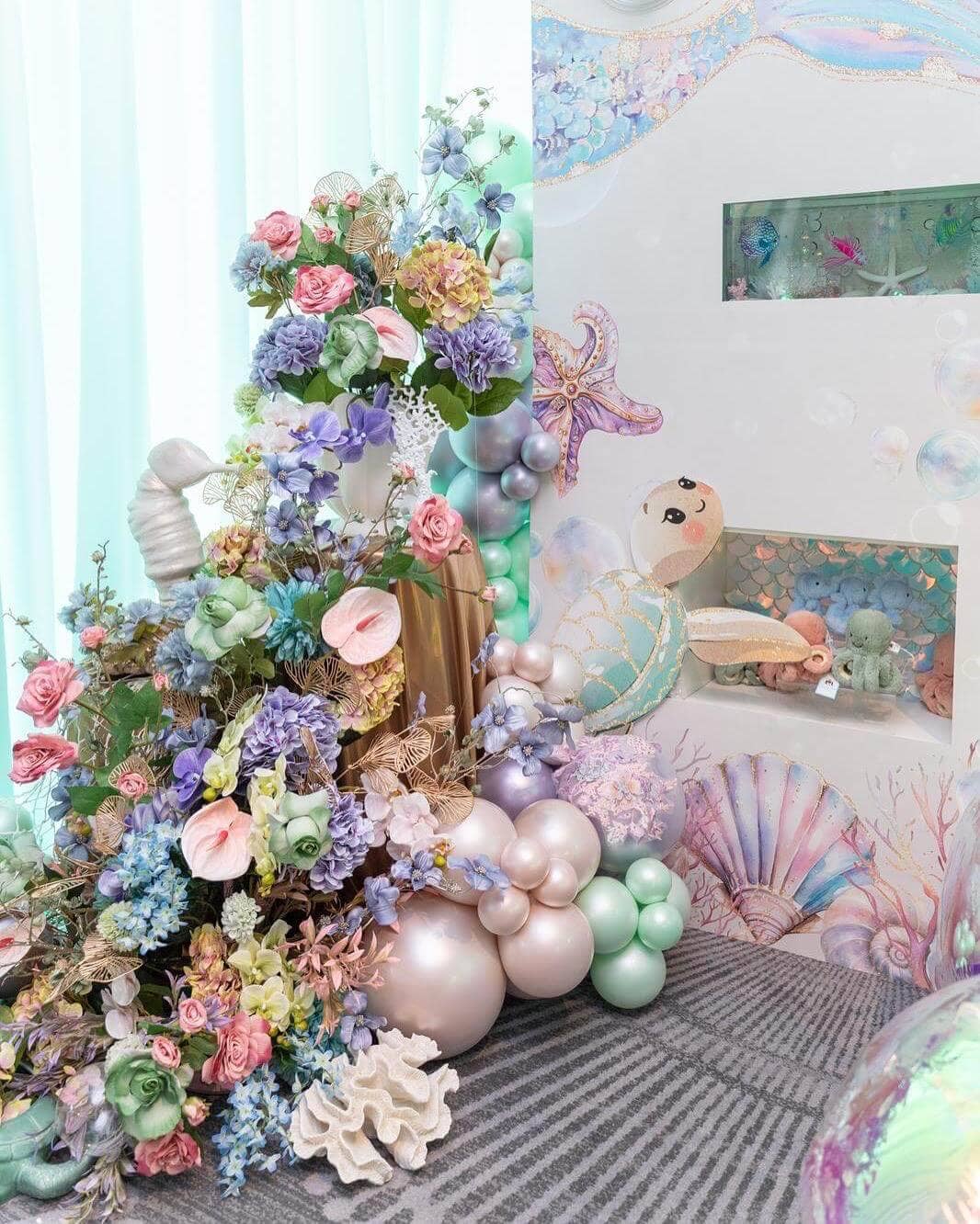 Under-the-sea birthday celebration with elaborate floral installations
