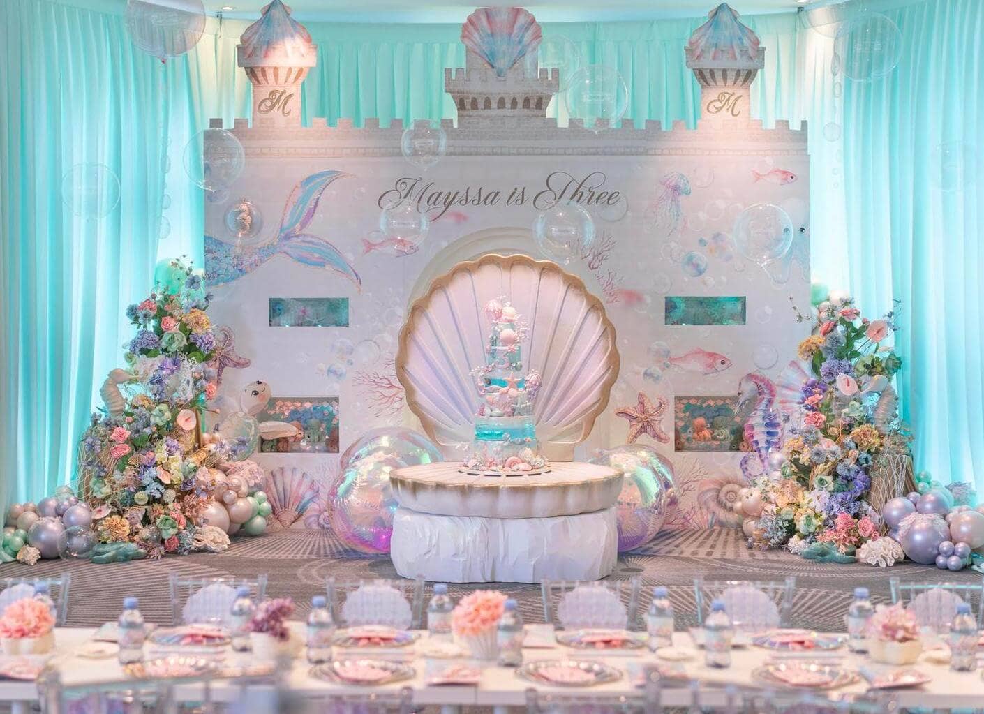 Spectacular mermaid-themed castle birthday setup with turquoise and pink decor