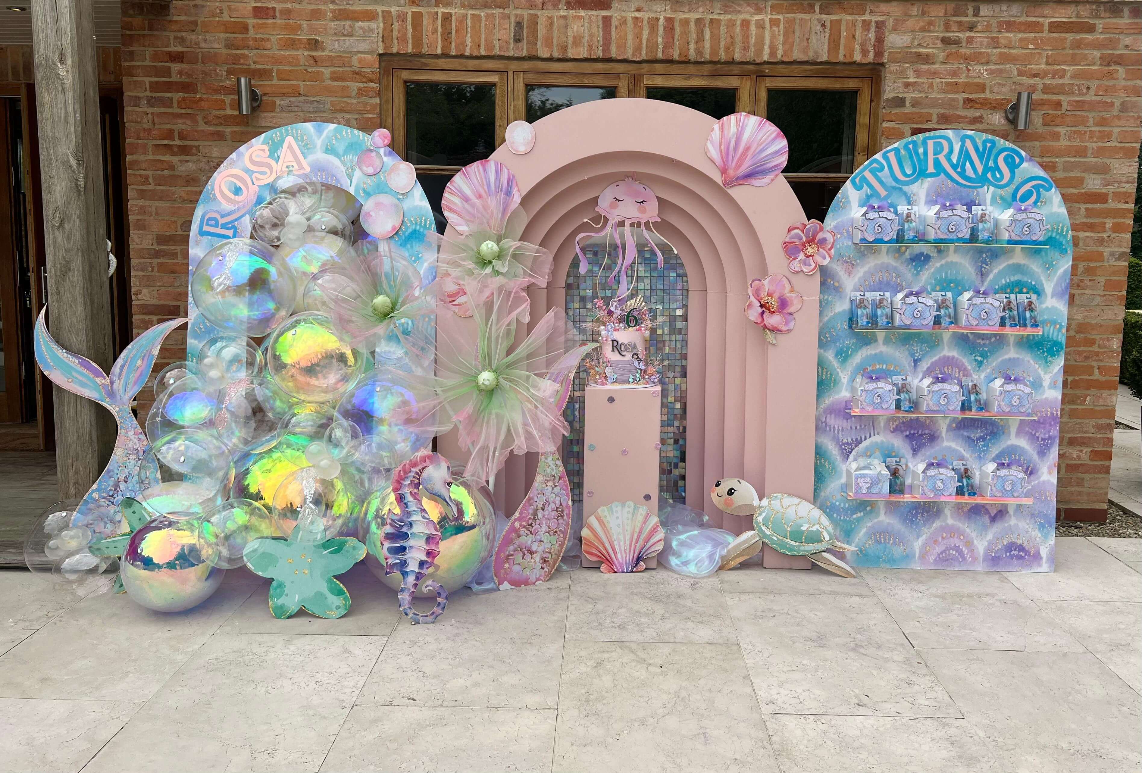 Enchanting mermaid-themed outdoor celebration with iridescent decorations