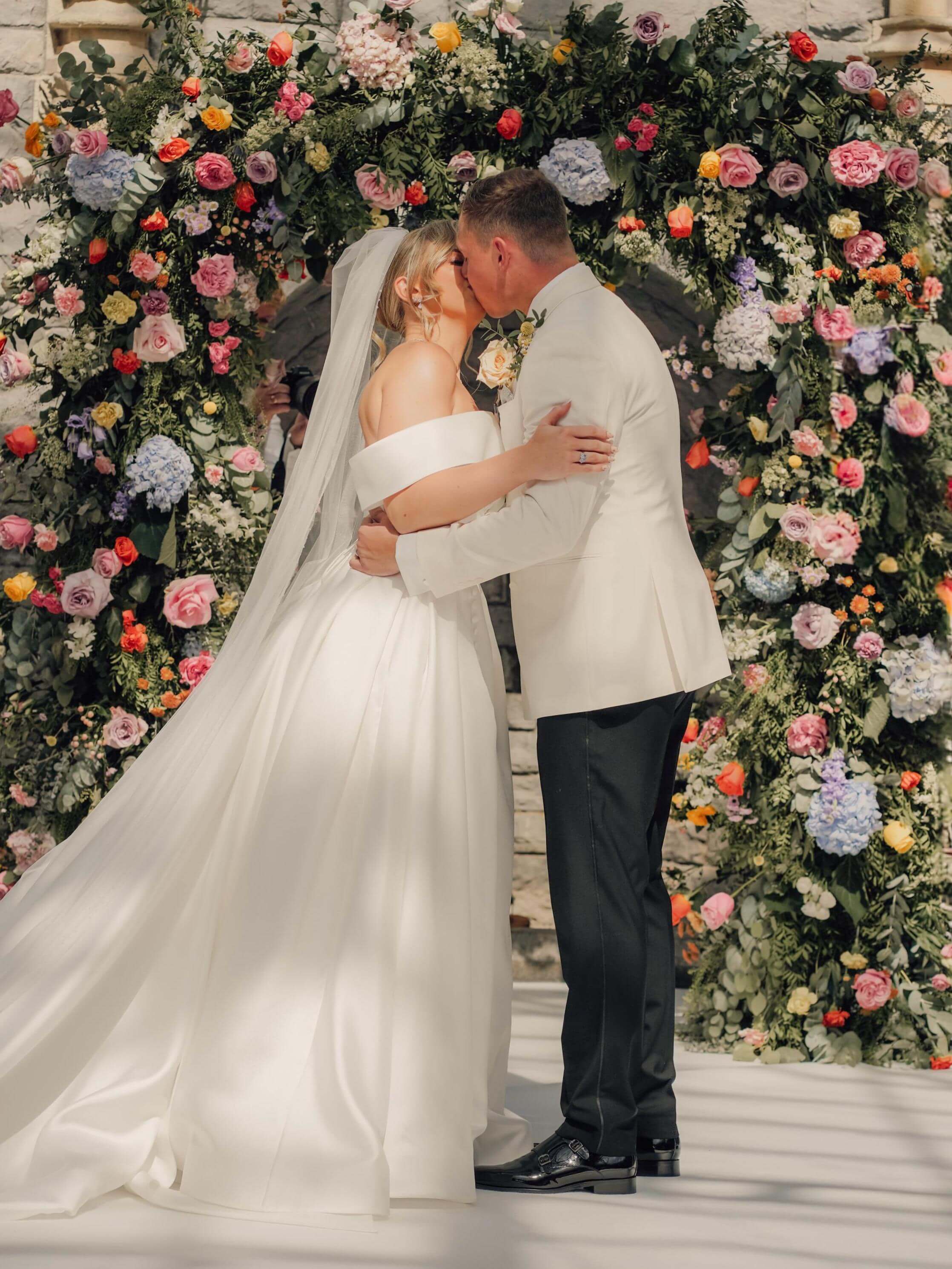Romantic wedding ceremony in the Cotswolds with elegant floral backdrop