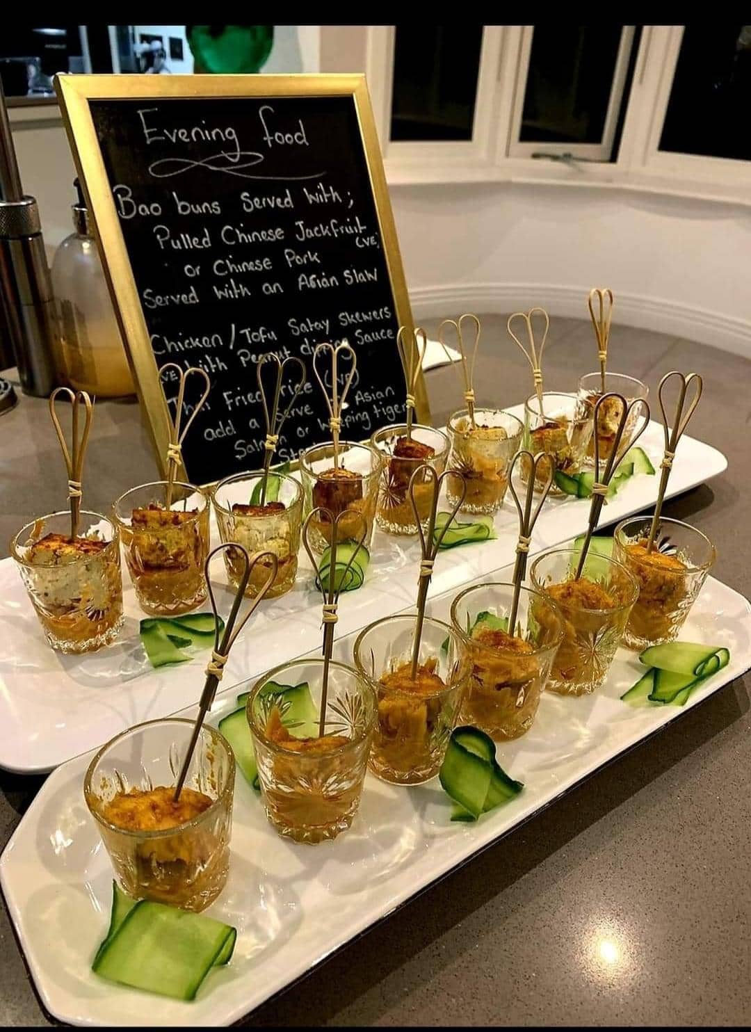 Elegant canapé presentation with gold heart picks and menu board