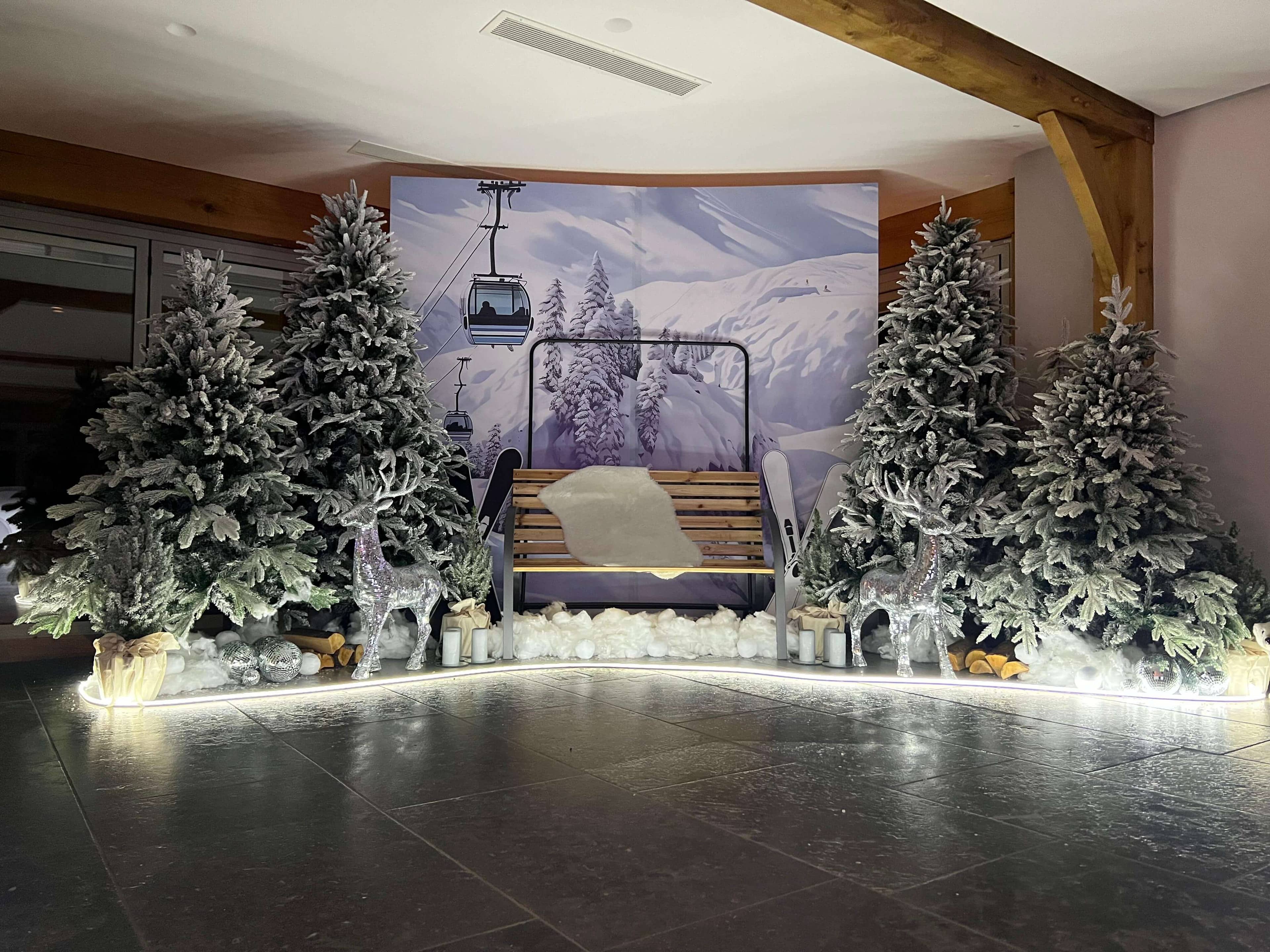 Elegant winter ski lodge themed event with snow-covered trees and ski lift backdrop