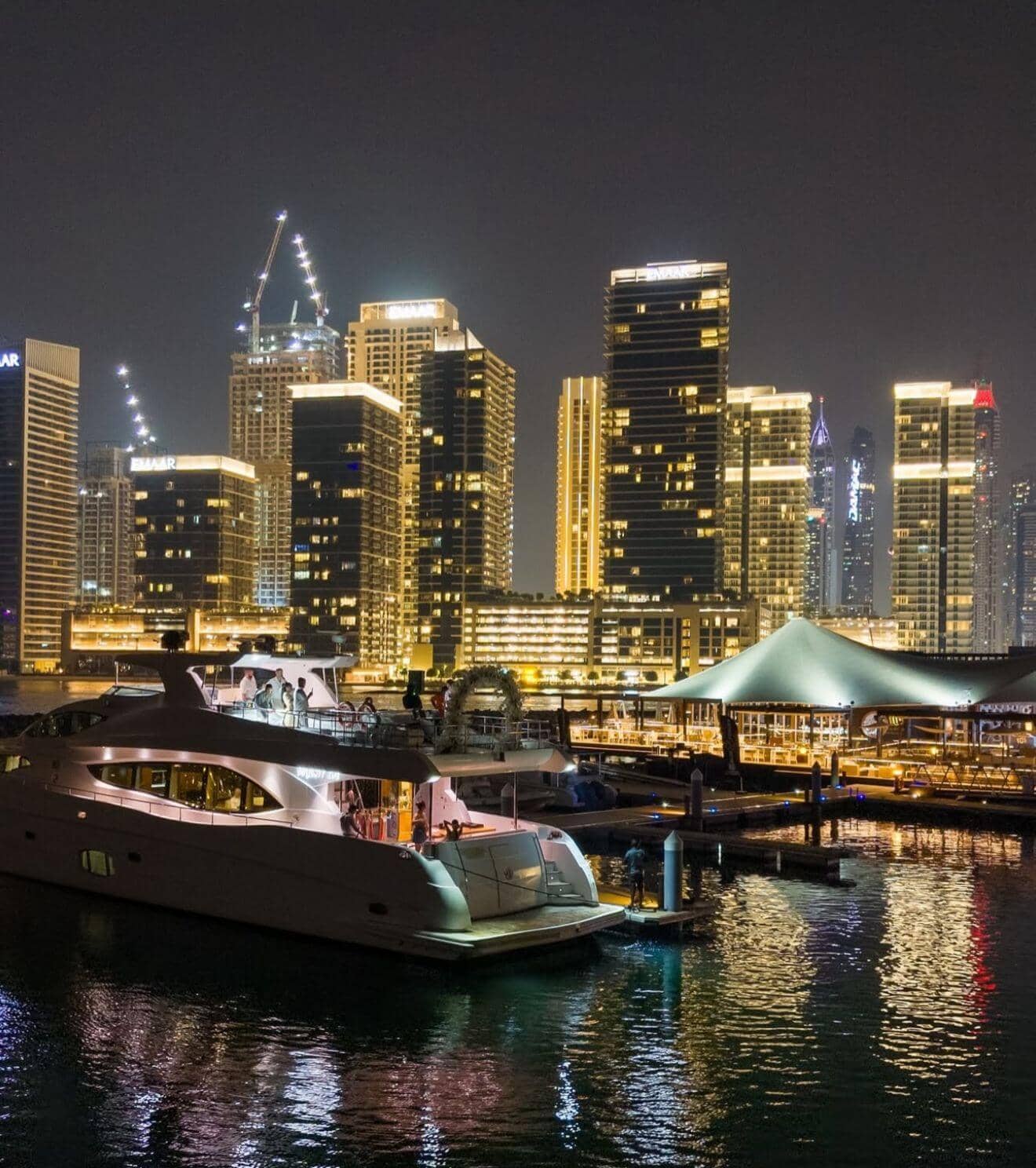 Luxury Dubai marina wedding venue at night with yacht and city skyline