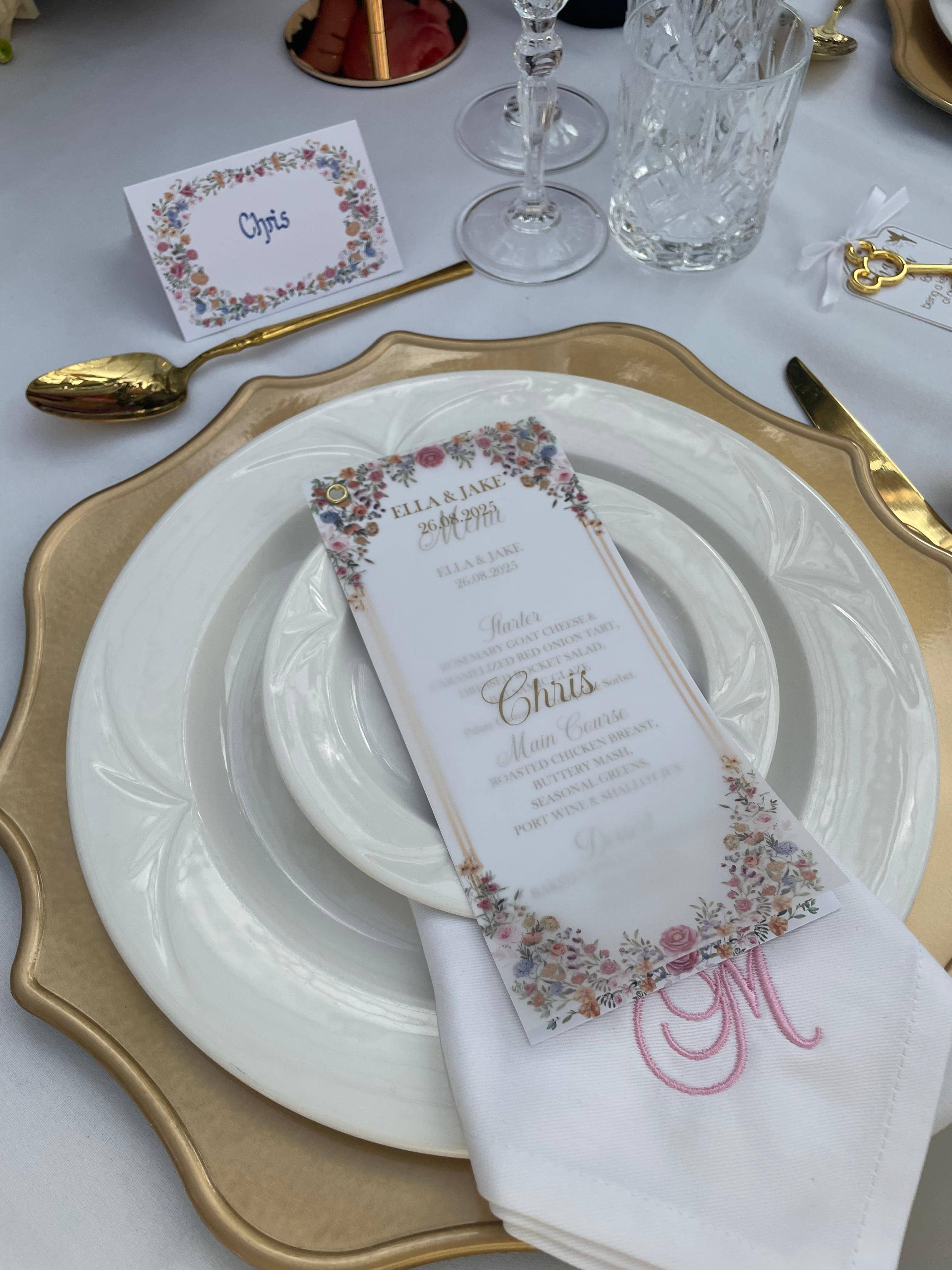 Elegant gold and white place setting with floral-bordered menu
