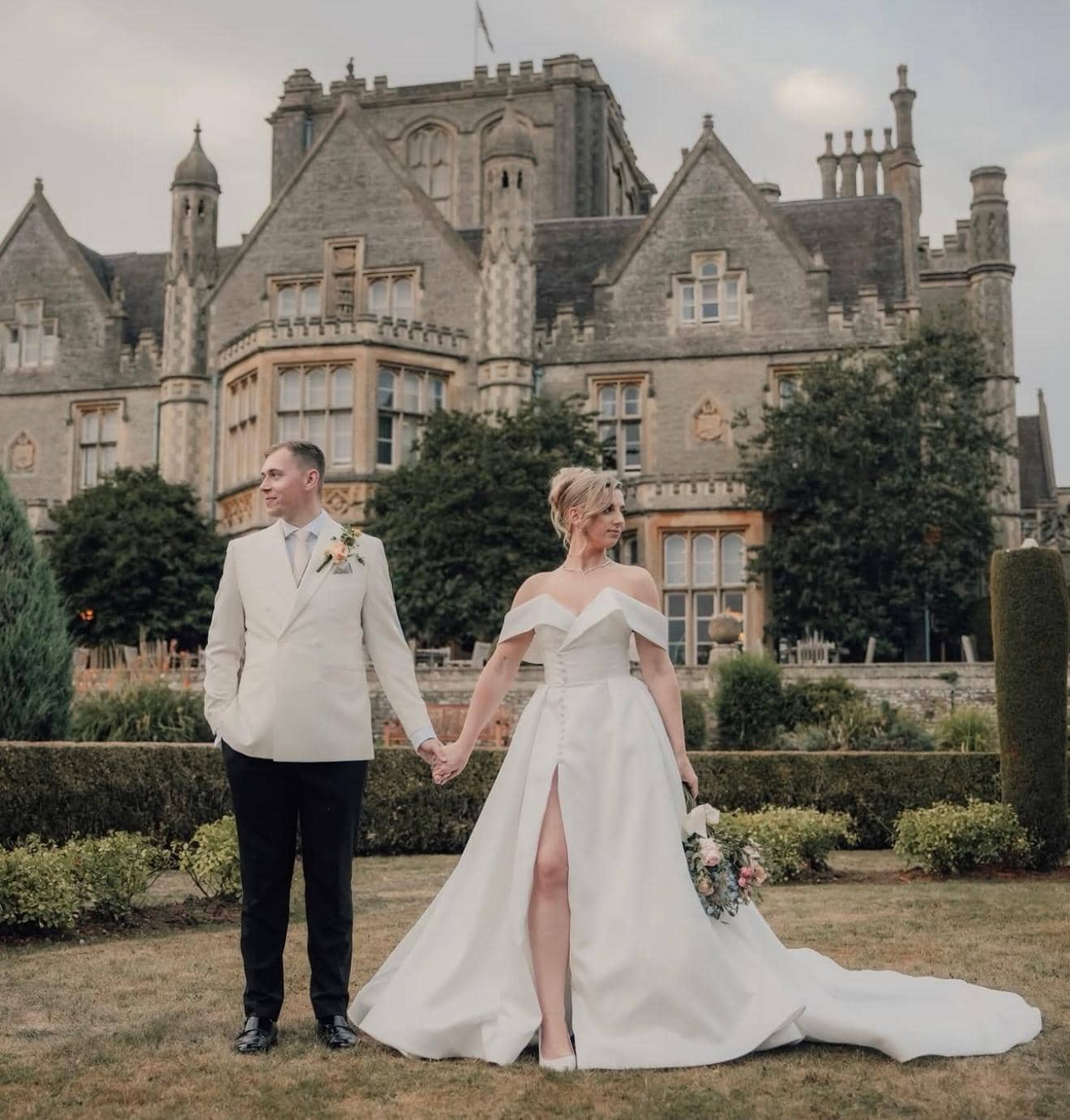 Elegant couple portrait at grand stone manor wedding venue in countryside